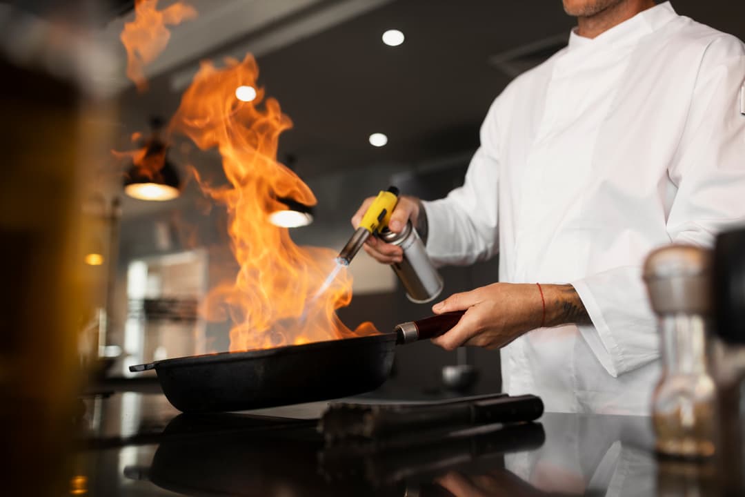 Chef working with fire in a professional kitchen